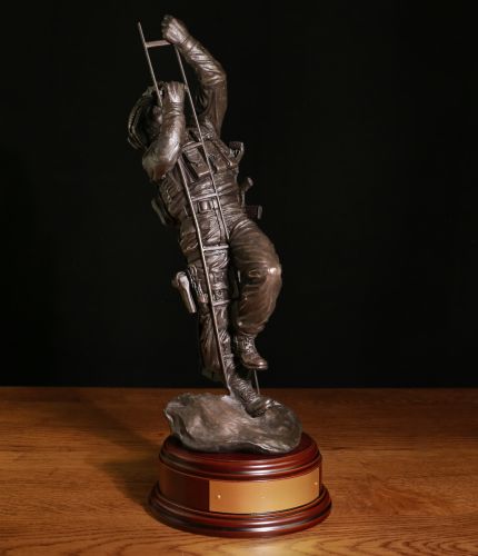 A military statuette of a Special Forces Navy Marine undertaking a ladder climb out of the sea during a ship assault. We include the standard wooden base and an engraved brass plate( if required) as part of any order.