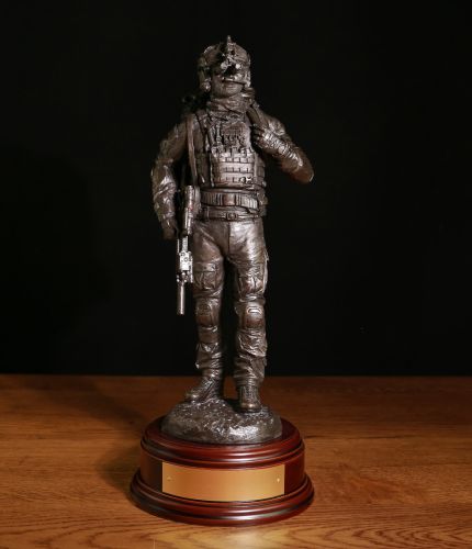A Special Forces Trooper with his kit preparing for departure on an Operation. We call this sculpture 'Mission Ready' as it depicts life in any one of the UK, US or Special Forces Regiments. We offer a choice of wooden base and engraved plate.