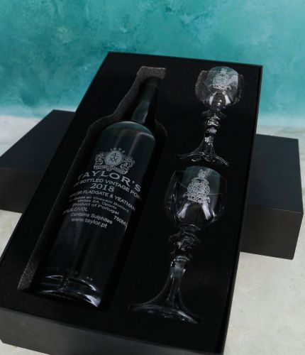 An engraved 75cl Bottle of Taylor's Late Bottled Vintage Port and two panel style crystal port glasses in a black foam cut out gift box. The Bottle and glasses can be engraved, and we sort this out with you after ordering.