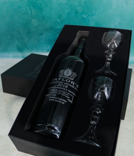 An engraved 75cl Bottle of Taylor's Late Bottled Vintage Port and two plain style crystal port glasses in a black foam cut out gift box. The Bottle and glasses can be engraved, and we sort this out with you after ordering.
