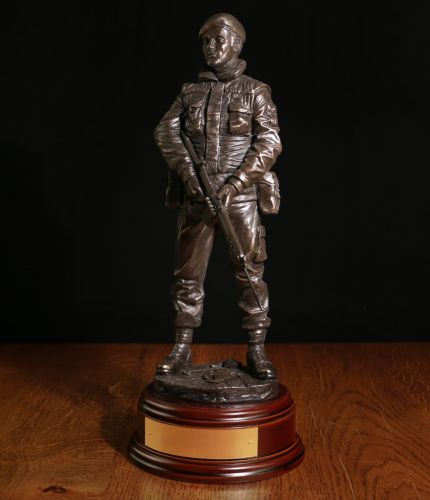 This 12" sculpture is of a Ulster Defence Regiment (UDR) soldier on a foot patrol in an urban part of Ulster. We include this wooden base as standard and offer an engraving plate free of charge.