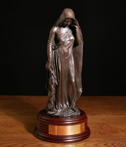 This is a faithful replica of the 'Mother of Canada' memorial that is a feature from the Canadian Vimy Ridge World War 1 Memorial. This is the Cold Cast Bronze version and she stands 12" tall on this wooden base and we offer a free engraved base plate.
