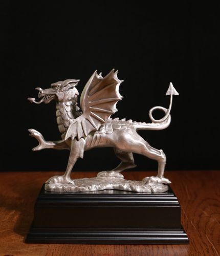 Classic Welsh Dragon cast in buffed pewter and engraved with a personal message making a lovely gift idea, a retirement award, long service presentation or gift. Wooden base of choice and engraved plate included.