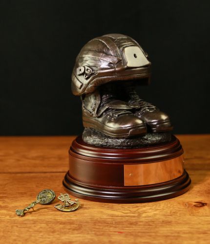 This is the current issue Combat Helmet and Boots. We offer it mounted on a range of wooden bases with your choice of cap badge. On the bigger bases we also offer an optional fully engraved brass plate.